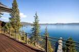 Experience breathtaking lake views from this stunning property, featuring a spacious wooden deck perfect for entertaining or relaxing.