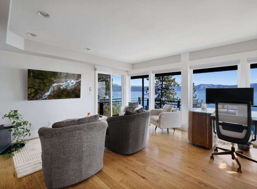 Experience breathtaking lake and mountain views from this stunning living space, featuring a modern aesthetic and ample natural light.