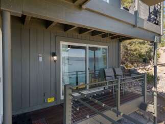 Enjoy breathtaking lake views from this charming property, featuring a spacious deck perfect for outdoor relaxation and entertaining.