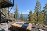Enjoy breathtaking lake views from this stunning property, featuring a modern fire pit area perfect for evening gatherings.