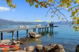 Enjoy breathtaking lake views from this stunning property featuring a private dock with seating and umbrellas, perfect for relaxing or entertaining.