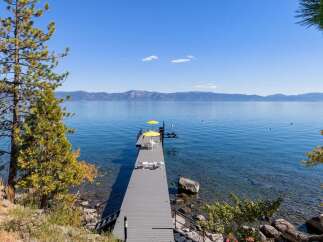 Enjoy breathtaking lake views from this stunning property featuring a private dock perfect for swimming, sunbathing, or launching your watercraft.