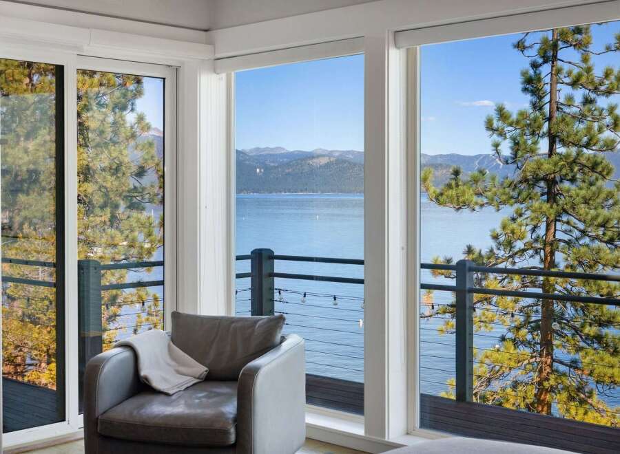 Experience breathtaking lake and mountain views from this stunning property, framed by large windows and a private balcony.