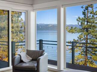 Experience breathtaking lake and mountain views from this stunning property, framed by large windows and a private balcony.