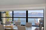 Experience breathtaking lake and mountain views from this stunning dining area, perfect for entertaining.