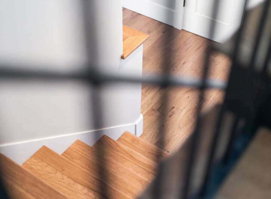 Step into this beautifully designed home featuring elegant hardwood stairs that lead to a well-lit landing.