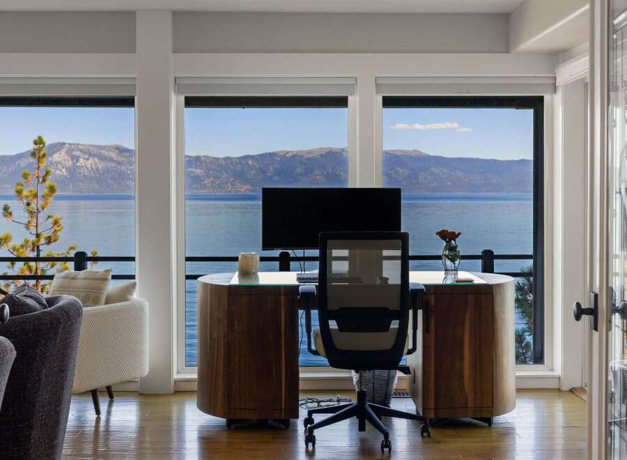 Experience breathtaking lake and mountain views from this stunning home office.