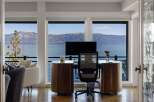 Experience breathtaking lake and mountain views from this stunning home office.