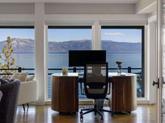 Experience breathtaking lake and mountain views from this stunning home office.