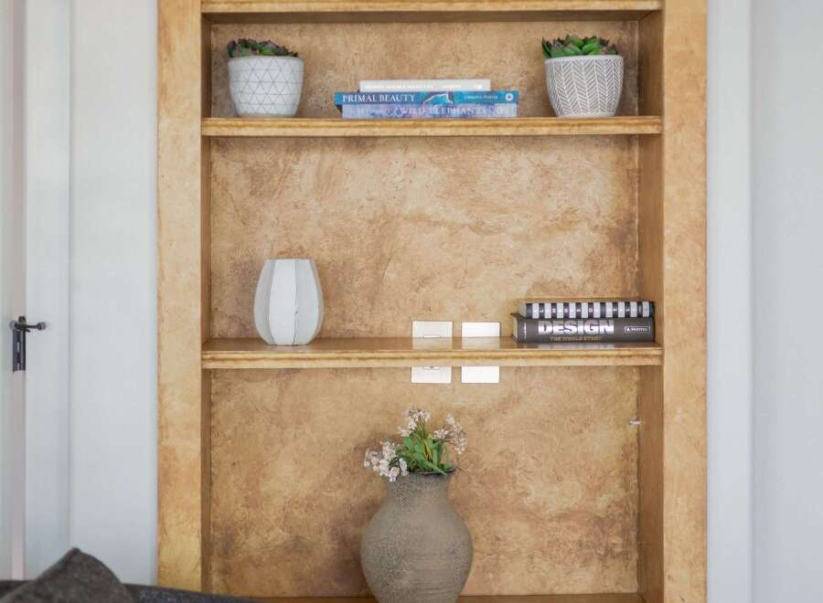 This arched built-in bookshelf offers a stylish and functional display solution for your home.