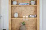 This arched built-in bookshelf offers a stylish and functional display solution for your home.