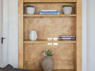 This arched built-in bookshelf offers a stylish and functional display solution for your home.
