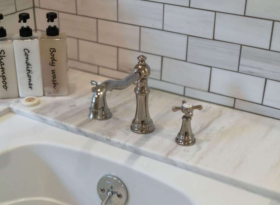 Experience luxury in this bathroom, featuring a sleek marble countertop and elegant chrome fixtures.