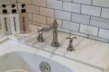 Experience luxury in this bathroom, featuring a sleek marble countertop and elegant chrome fixtures.