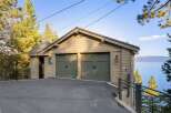 This charming property features a rustic two-car garage with classic green doors, perfect for storing vehicles and outdoor equipment.