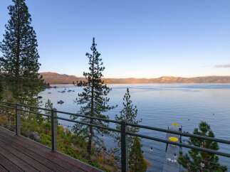 Experience breathtaking lake views from this stunning property, featuring a spacious deck perfect for entertaining or quiet relaxation.