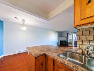 This spacious living area features a modern kitchen island with a double sink, perfect for entertaining.