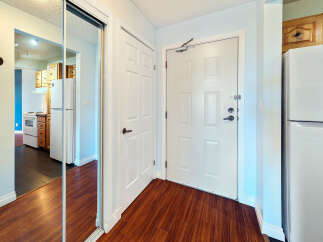 Step into a welcoming entryway featuring a full-length mirrored closet, perfect for checking your outfit before heading out.