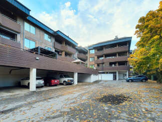 Discover this charming apartment building nestled amidst vibrant autumn foliage.