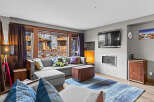 Step into this inviting living room, featuring a plush sectional sofa adorned with decorative pillows, perfect for cozy gatherings.