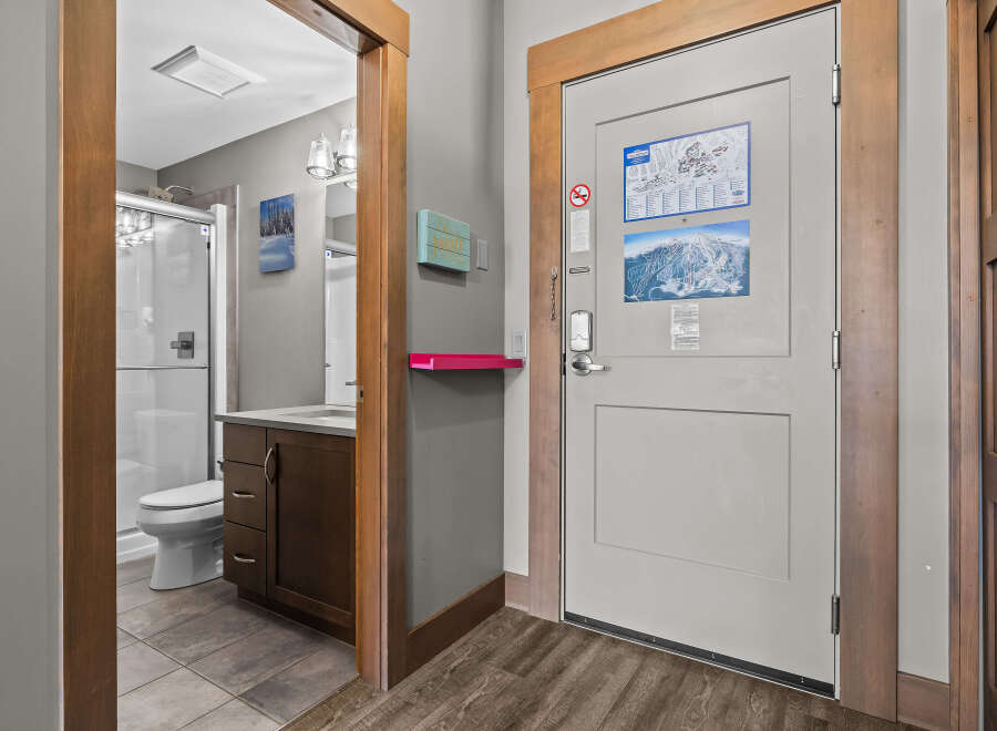 Step into this inviting space featuring a well-appointed bathroom with a modern vanity and a glass-enclosed shower.