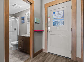 Step into this inviting space featuring a well-appointed bathroom with a modern vanity and a glass-enclosed shower.