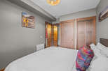 This bedroom features a comfortable bed with crisp white linens and a decorative accent pillow.