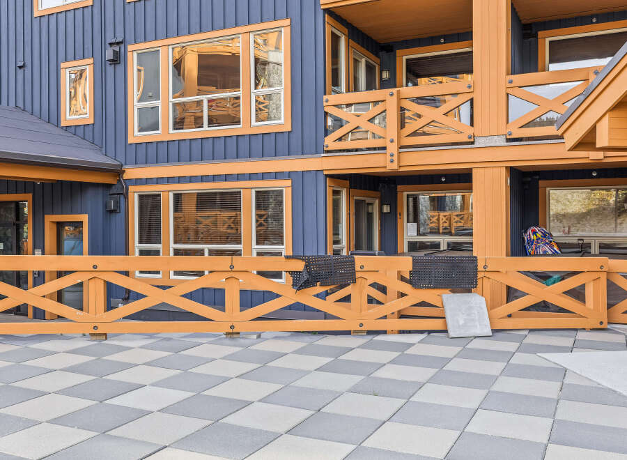 Experience the charm of this multi-story building featuring a striking blue exterior accented with warm orange trim.