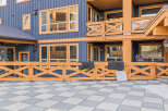 Experience the charm of this multi-story building featuring a striking blue exterior accented with warm orange trim.