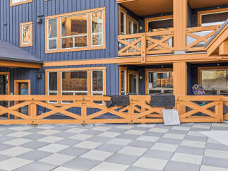 Experience the charm of this multi-story building featuring a striking blue exterior accented with warm orange trim.