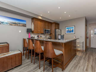 This modern kitchen features rich wood cabinetry and a sleek granite countertop, perfect for entertaining.