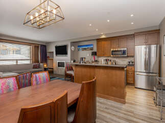 This spacious open-concept living area features a modern kitchen with stainless steel appliances, granite countertops, and ample cabinet space.