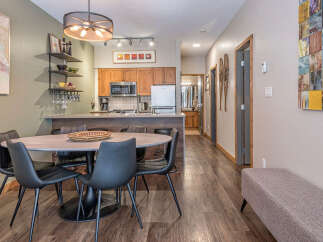 This modern condo features an open-concept living space with a sleek kitchen and a stylish dining area perfect for entertaining.