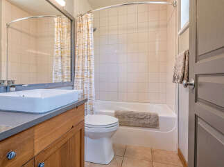 This bathroom features a spacious vanity with a vessel sink and ample counter space, perfect for your morning routine.
