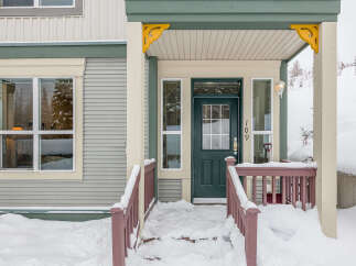 Welcome to this charming home featuring a covered porch perfect for enjoying the winter wonderland.