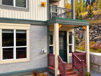 Discover this charming home featuring a welcoming entrance with a dark green door and a number '109' prominently displayed.