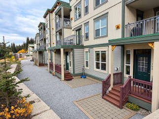 Discover modern living in this multi-story apartment complex, nestled amidst a scenic mountain landscape.
