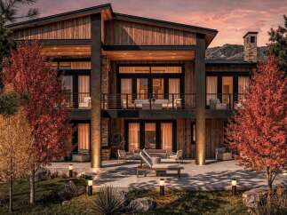 Experience luxury mountain living in this stunning modern home, featuring a striking wood and stone exterior that blends seamlessly with the natural landscape.