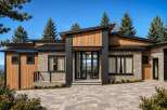 Experience modern luxury in this stunning home, featuring a striking architectural design with a blend of natural stone and warm wood accents.