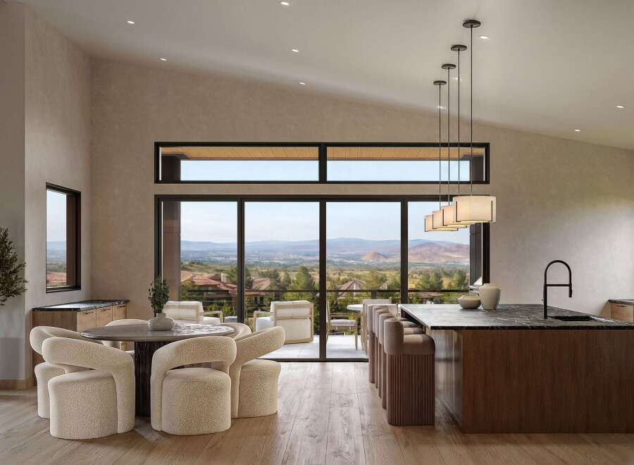 Experience modern luxury in this open-concept living space, featuring a gourmet kitchen with a sleek island and bar seating, perfect for entertaining.