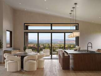 Experience modern luxury in this open-concept living space, featuring a gourmet kitchen with a sleek island and bar seating, perfect for entertaining.