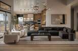 Experience modern luxury in this open-concept living space, featuring a spacious sectional sofa, elegant armchairs, and a striking abstract art piece.