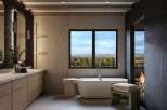Experience luxury and tranquility in this stunning bathroom, featuring a freestanding soaking tub with breathtaking panoramic views of the surrounding landscape.