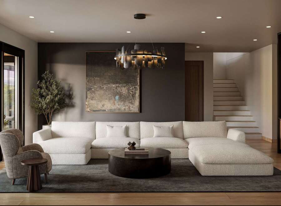Experience modern luxury in this spacious living room, featuring a plush, sectional sofa and a striking contemporary chandelier.