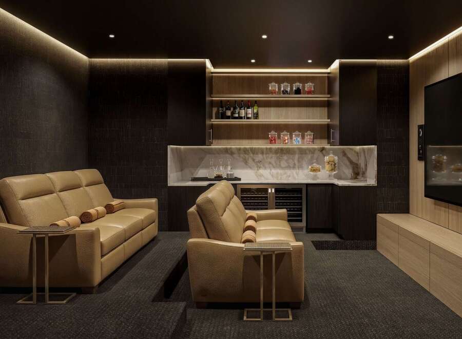 Experience ultimate relaxation in this luxurious home theater, featuring plush leather seating and a fully equipped wet bar.