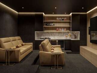Experience ultimate relaxation in this luxurious home theater, featuring plush leather seating and a fully equipped wet bar.