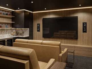 Experience cinematic luxury in this modern home theater, featuring plush leather seating and a large screen for an immersive viewing experience.