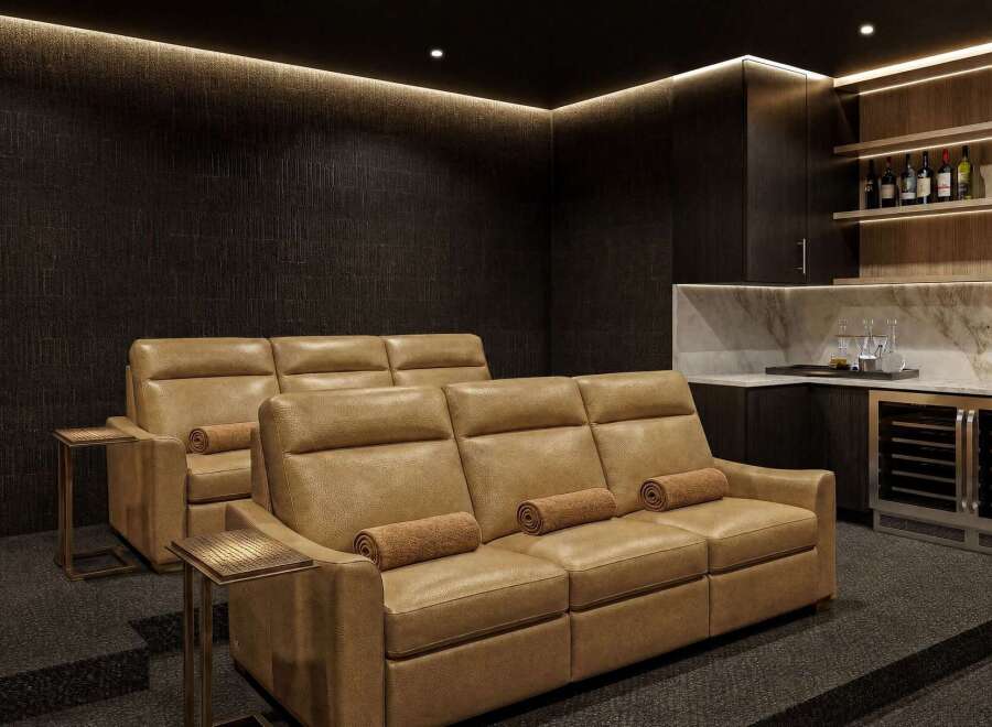 Experience luxury home entertainment in this sophisticated media room, featuring plush, reclining leather seating perfect for movie nights.