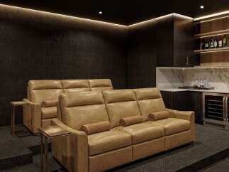 Experience luxury home entertainment in this sophisticated media room, featuring plush, reclining leather seating perfect for movie nights.