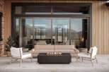Experience luxurious outdoor living with this stunning patio setup, featuring a modern gas fire pit as the centerpiece.